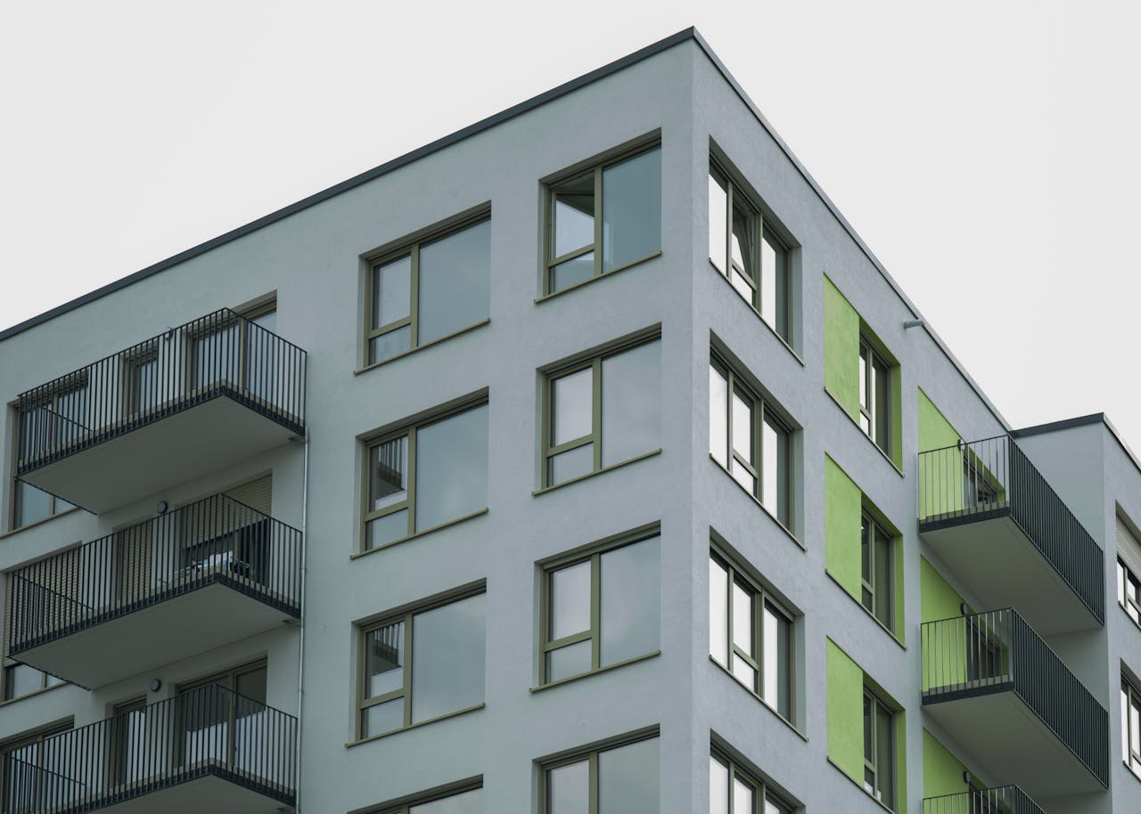 Contemporary architecture of a modern apartment complex with visible balconies and colorful accents.